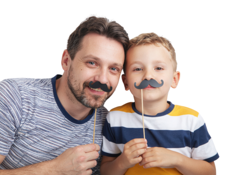A cheerful father and son pose together, both wearing playful mustache props against a solid black background.