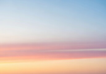 A minimalist dawn sky with a smooth gradient from soft peach near the horizon to pale blue above. No harsh contrasts, only gentle color transitions and diffused light. The atmosphere is calm and open,