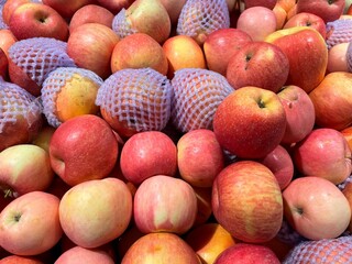 Red ripe apples on display in fruit shops are sold for juice or eaten directly
