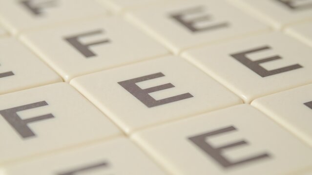 A Set of Scrabble Tiles Featuring the Letters 'F' and 'E' Close-Up - Powered by Adobe
