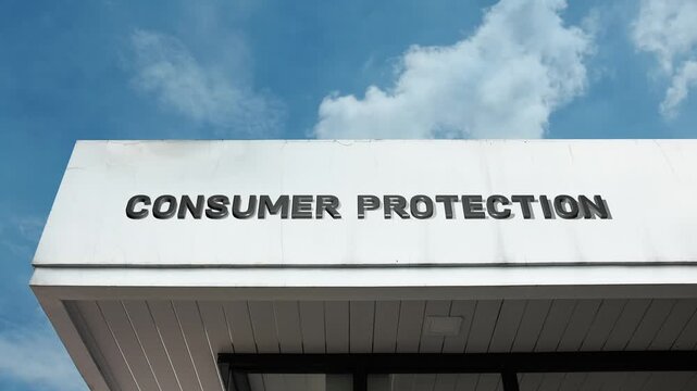 Consumer Protection word sign displayed on the exterior of a government building under a clear blue sky, symbolizing consumer rights, safety, advocacy, regulation, and public service