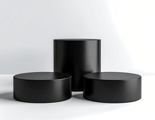 3 black cylinders arranged on a white surface