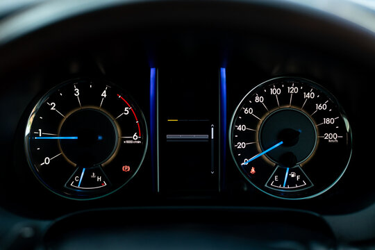 Car Dashboard Close-Up with Speedometer and Tachometer Display