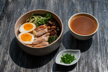 Ramen soup in a cafe. Broth separately. 