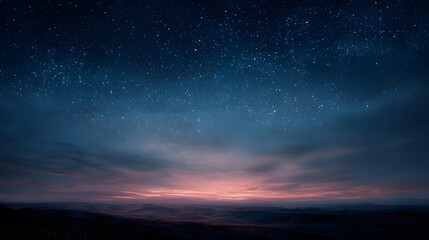 Fototapeta premium A vast expanse of starry night sky over a twilight horizon glowing with soft colors