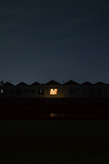 Residential Houses at Night with Lit Window