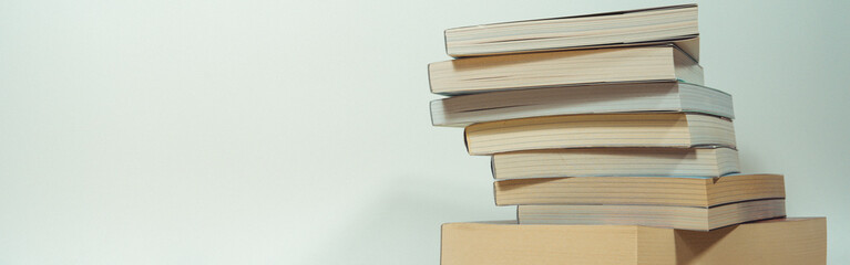 stack of book on table with soft focus library or bookstore background