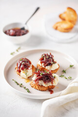 Sandwich or toast with cheese and onion marmalade on the table. French cuisine.