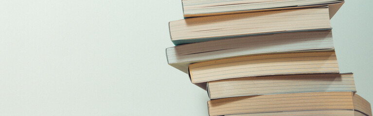stack of book on table with soft focus library or bookstore background