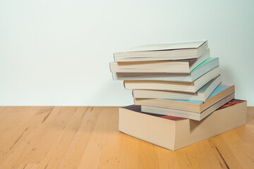 stack of book on table with soft focus library or bookstore background