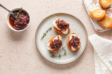 Sandwich or toast with cheese and onion marmalade on the table. French cuisine. Top view
