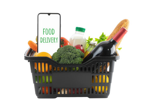A black grocery basket filled with fresh produce, drinks, and a sign displaying "Food Delivery. - Powered by Adobe