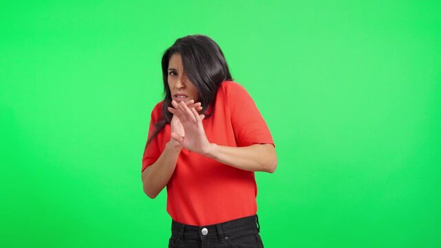 Scared woman recoiling in fear and disgust on green screen