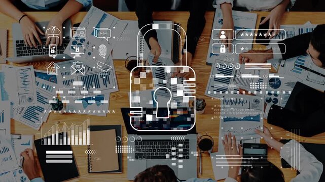 A diverse business team engages in a collaborative meeting focusing on data security, surrounded by laptops and financial documents, emphasizing protection strategies. Raster