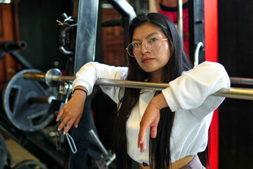 Woman posing in gym feeling strong and healthy for fitness