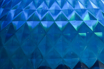 Fototapeta premium blue surface texture with triangular geometric patterns and light reflection effects