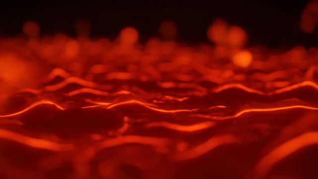 Red glowing liquid with slow waves shows abstract fluid motion this is a very hot and viscous texture this is a great sci-fi and energy concept this is a very dramatic background