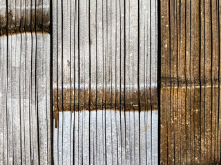Vertical dry bamboo fence texture for pattern and background. Decorative old bamboo fence or wall texture background for design. Split bamboo pieces bundled together to form a simple fence or wall.