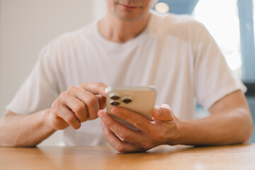 person using a modern smartphone indoors, emphasizing communication, technology daily digital lifestyle in a relaxed environment.