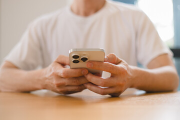 person using a modern smartphone indoors, emphasizing communication, technology daily digital lifestyle in a relaxed environment.