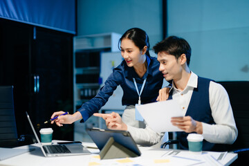 Asian colleagues collaborating on project in modern office, teamwork and communication for business success.