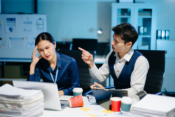 Asian manager scolding employee under stress, workplace conflict and frustration in modern office showing tension and miscommunication.