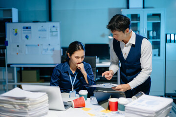Asian manager scolding employee under stress, workplace conflict and frustration in modern office showing tension and miscommunication.