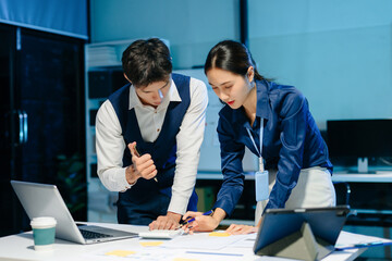 Asian business team discussing project planning and strategy in modern office, showing teamwork, collaboration, and productivity.