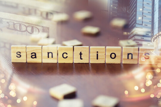 Economic sanctions against Russia because of Ukraine. Stacked coins on table. Multiple exposure city, dollar bills, judge hammer.