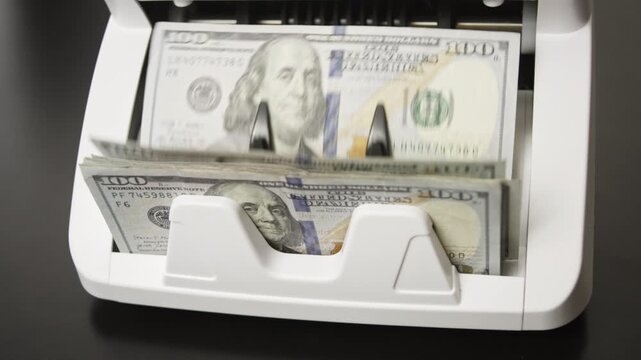 Money counting process. Paper money in counting machine. Business and finance concept with money. UDS in motion. Counting paper money bills. Banking and cash concept. Savings dollars theme.