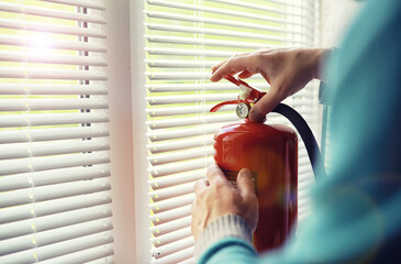 Fire extinguisher has hand engineer inspection checking pressure gauges to prepare fire equipment...