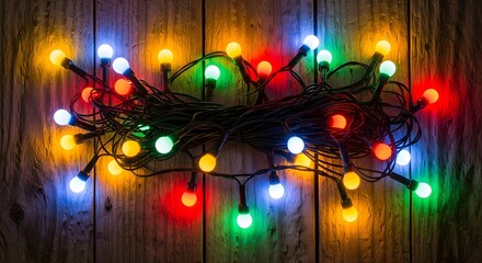 Colorful christmas lights on wooden background for festive season