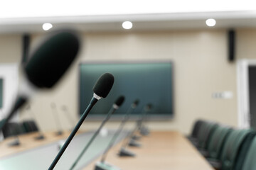 modern conference room with a large screen, multiple microphones