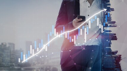 A businessman is engaged with a smartphone against a backdrop of a rising financial chart,...