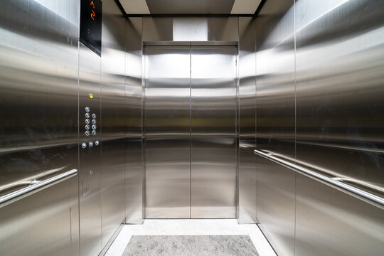 modern elevator with stainless steel walls, control buttons, and a digital floor display, clean and sleek