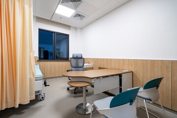 hospital examination room with a bed, desk