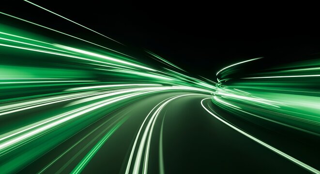 Abstract green light trails with motion blur effect against a dark background