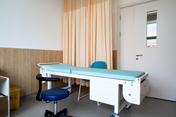 hospital examination room with a bed, desk