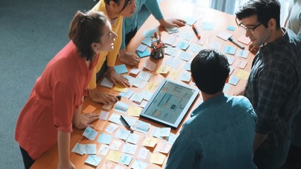 Top view of skilled programmer brainstorming idea about mobile phone interface while develop app...