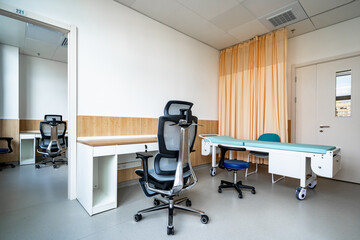 hospital examination room with a bed, desk