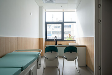 hospital examination room with a bed, desk