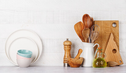 Kitchen utensils and spices on table