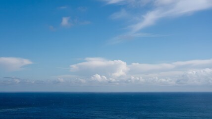Fototapeta premium Tranquil seascape with blue sky and calm ocean horizon, peaceful natural background for travel, wellness, relaxation, freedom, or coastal inspiration concept