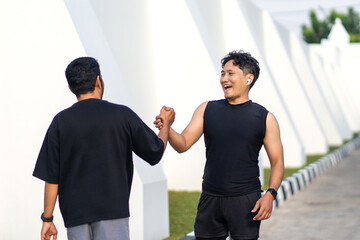 Asian Indonesian Men High Five After Sport Running Exercise Outdoors