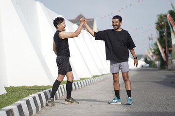Asian Indonesian Men High Five After Sport Running Exercise Outdoors