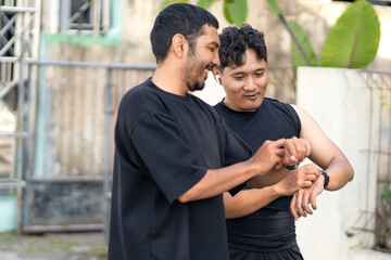 Asian Indonesian Men Checking Smartwatch After Running Exercise