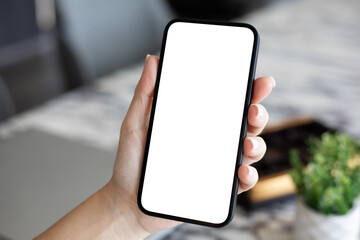 woman hand holds phone with isolated screen above office cafe