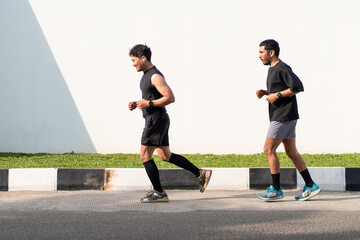Asian Indonesian Men Running Together Outdoors for Exercise