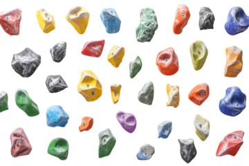 Collection of colorful climbing holds isolated on transparent background. Rock climbing wall with colorful rock climbing holds isolated on white background.