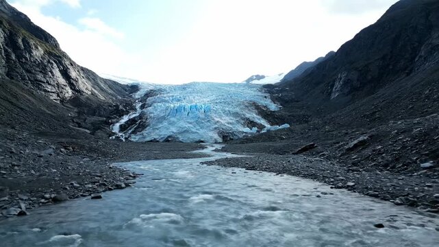 Glacier melting river environmental awareness tone cinematic documentary style. glacial thaw waterway ecological sensitivity motion picture film aesthetic.